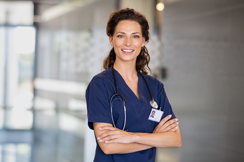 Smiling nurse in a hospital corridor