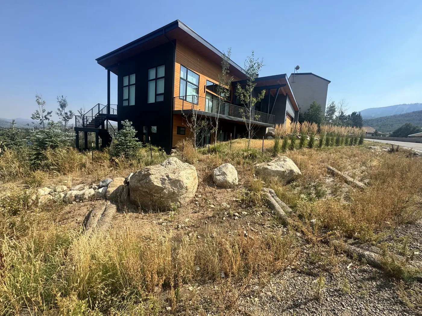 Rock retaining and gravel landscaping at a modern home