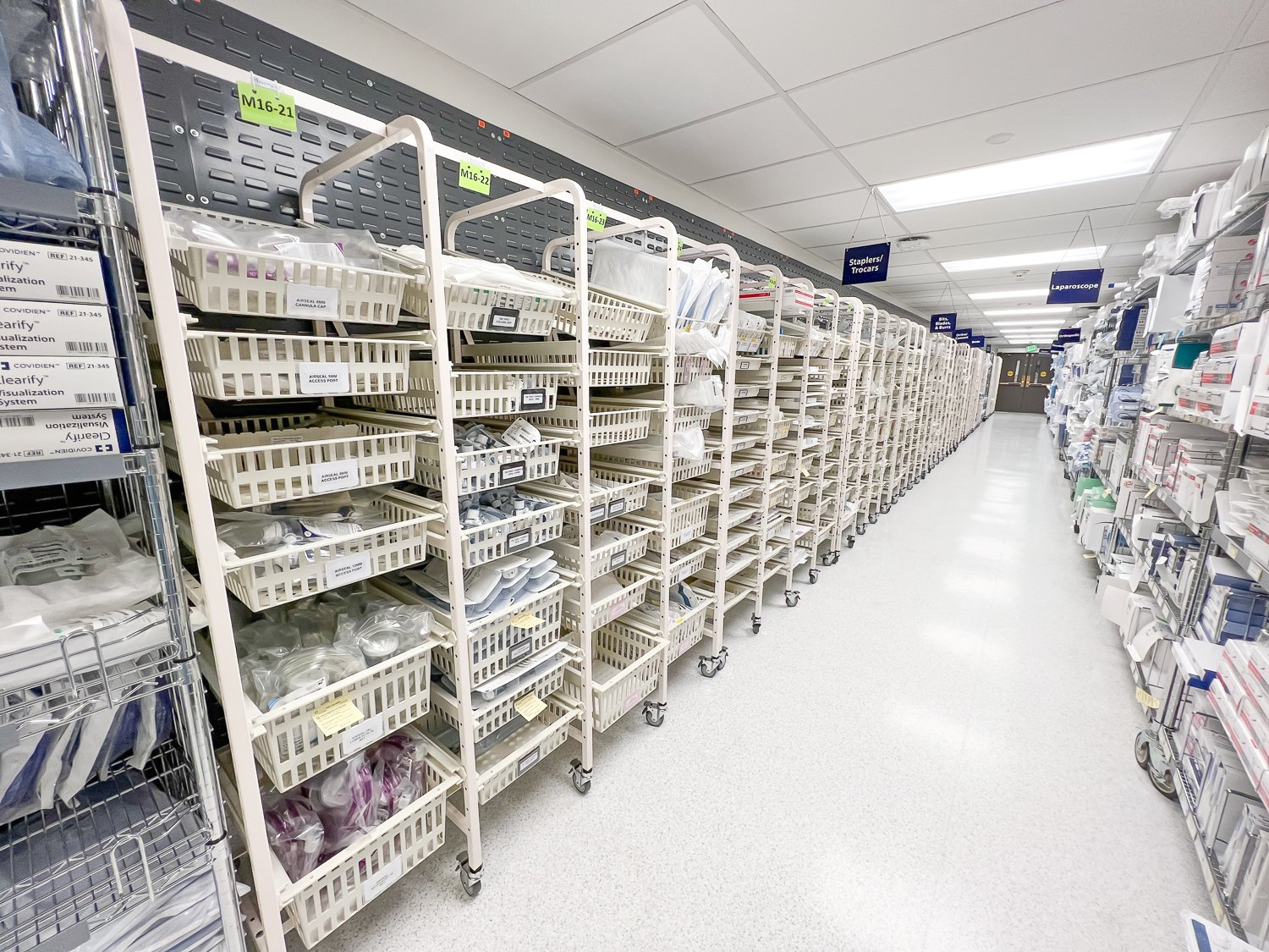 Organized acute-care supply aisle outfitted with UNICAS carts and shelving