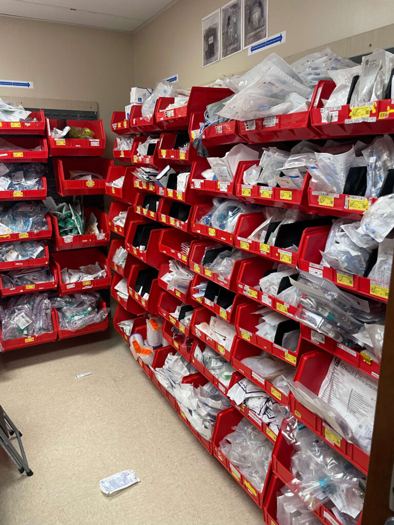 Anesthesia supply room before UNICAS — cluttered wall bins